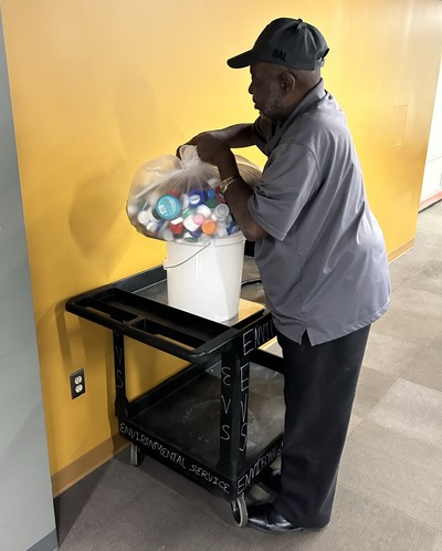 EVS staff member weighs collected bottle caps