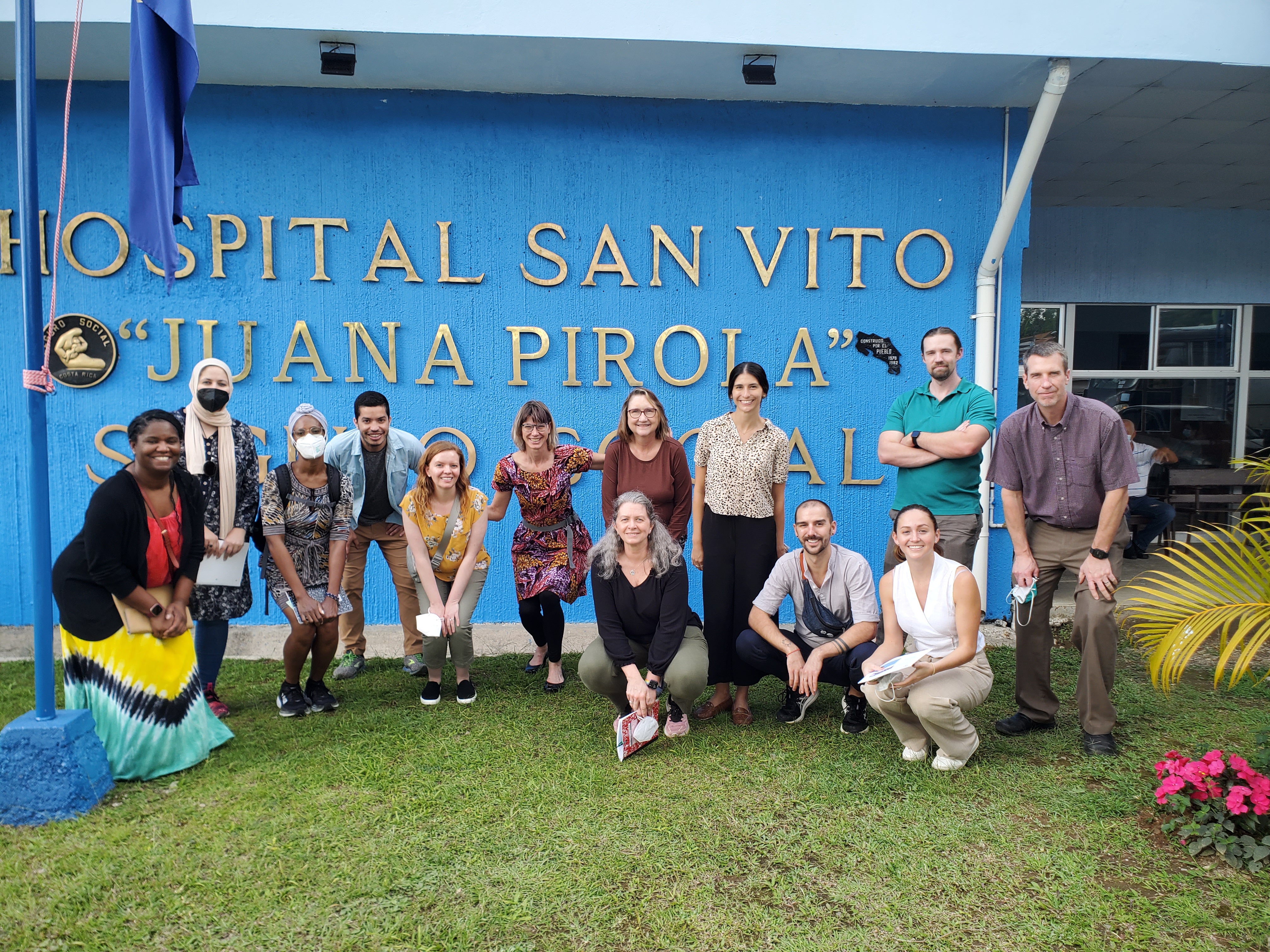 A group of people pose for a photo outside a hospital in Costa Rica.