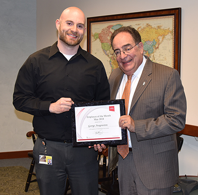 Employee of the Month George Anagnostou recieving his certificate from UMB's president