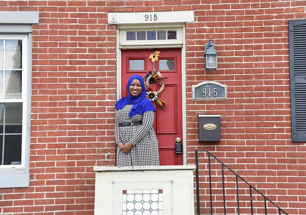 Lauren Kareem standing in front of the entrance of her home