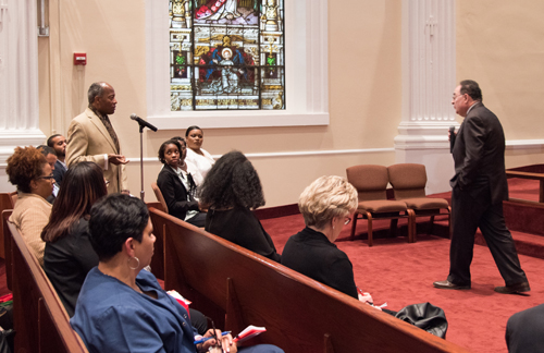 Wali Mutazammil, president of the Poppleton Community Neighborhood Association, poses a question to University of Maryland, Baltimore President Jay A. Perman, MD, at a town hall meeting for the Partnership for West Baltimore on May 4 at Carter Memorial Church of God In Christ.