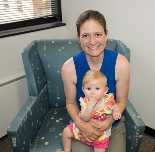 University of Maryland School of Social Work student Amy Greensfelder and her daughter, Georgianna Ashford, check out the school's new lactation center.