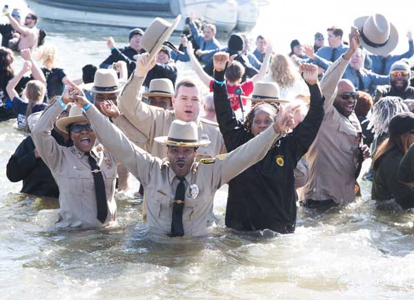 The University of Maryland, Baltimore Police Force Polar Bear Plunge team, UMB Cool, led by Sgt. Matthew Johnson (center), braves the icy Chesapeake Bay to raise money for Special Olympics Maryland. 