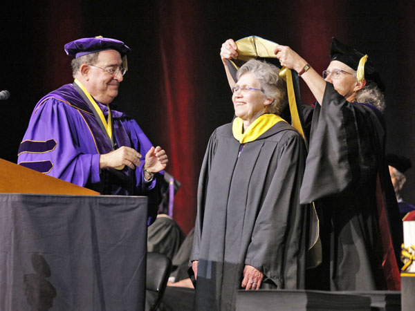 President Jay A. Perman, MD, and University of Maryland School of Nursing Dean Jane M. Kirschling, PhD, RN, FAAN, bestow an Honorary Doctor of Public Service degree upon Mary Catherine Bunting, MS ’72, CRNP, an alumna of the School of Nursing who represented the Bunting family in 2017 when her grandfather, George Avery Bunting, was named a Founding Pharmapreneur by the School of Pharmacy.  