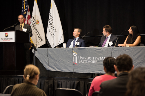 Professor Andrew Coop, PhD, FAAPS, associate dean for academic affairs at the School of Pharmacy, speaks about opioids research during a panel discussion including, l-to-r, Associate Professor Eric Weintraub, MD, of the School of Medicine, and Dean Richard Barth, PhD, MSW, and Associate Professor Nalini Negi, PhD, MSW, both of the School of Social Work. 