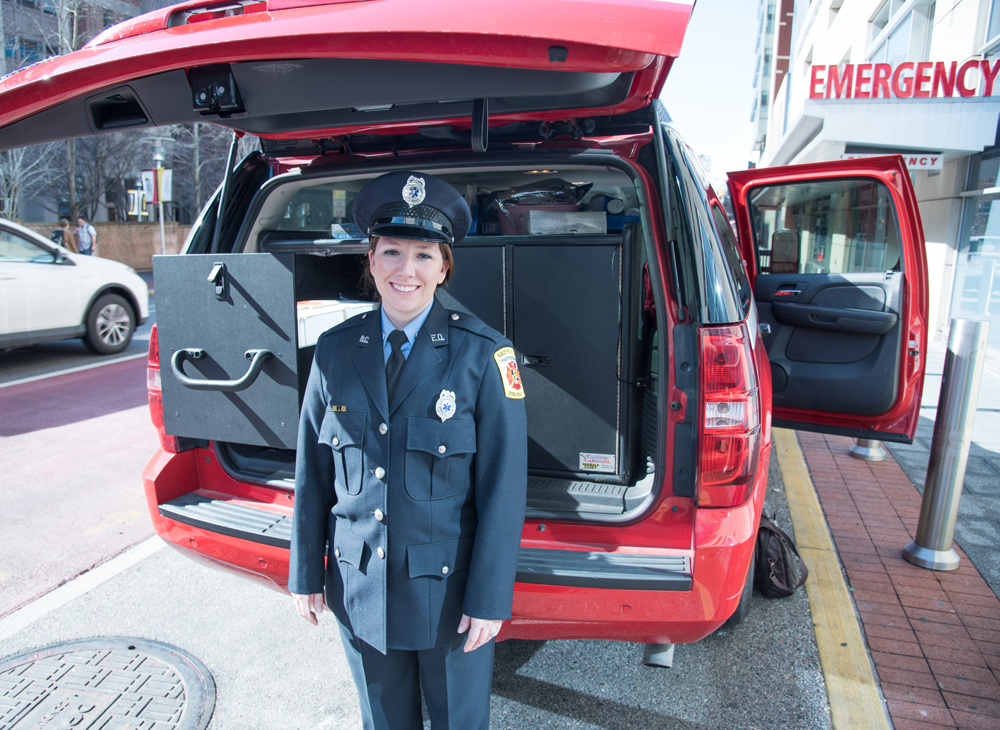 Jessica Thomas, CRT, a paramedic in the  Baltimore City Fire Department, is shown with one of two vehicles used in the MIH-CP program in West Baltimore.