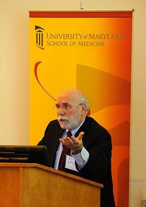 Myron Levine, PhD inset photo, shows Levine speaking at podium at the Festival of Science