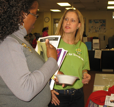 UM School of Social Work research assistant professor Christine Callahan, PhD, MSW, discusses ways to build assets with a Baltimore resident during a Financial Social Work Initiative outreach activity held at the Mayor's Office of Employment Development. Building financial capability for all is among the Grand Challenges.
 