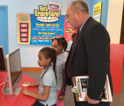 Richard Manski, DDS, PhD, MBA, executive director of the National Museum of Dentistry and professor and chair of Dental Public Health at the University of Maryland School of Dentistry, interacts with children who are in the second grade at Belmont Elementary School.