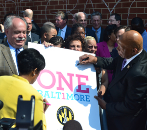 Mayor Stephanie Rawlings-Blake and Rep. Elijah Cummings are the first of many to sign a #OneBaltimore poster.