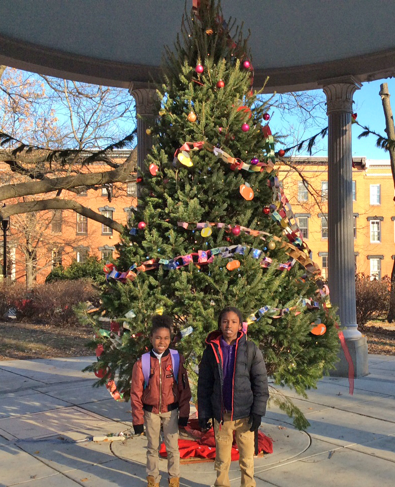 James McHenry Elementary/Middle School students Ti'yah and Robert pose at the Christmas tree in Union Square, one of seven neighborhoods in the Southwest Partnership.