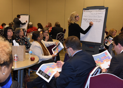 Sarah Pick of the Institute for Genome Sciences in the School of Medicine jots down notes from the Health, Justice, and Social Impact group.