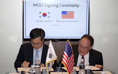 UMB President Jay Perman signs an MOU with Ajou University President Dong Yeon Kim in Korea.