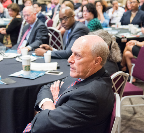 UMB Chief Academic and Research Ofcr. and Sr. VP Bruce Jarrell, MD, FACS, asks a question as Roger J. Ward, JD, MPA, Chief Accountability Ofcr. and Graduate School Vice Dean; Peter J. Murray, PhD, Chief Information Ofcr. and VP; and others look on.