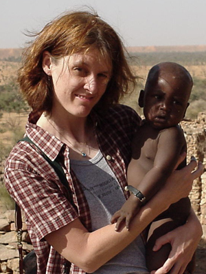 Kirsten Lyke, MD holds child in Burkino Faso.