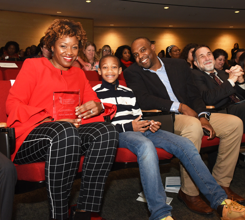 Cherita Adams, MBA, MS, and her family are all smiles after she was recognized with the Outstanding UMB Staff Award