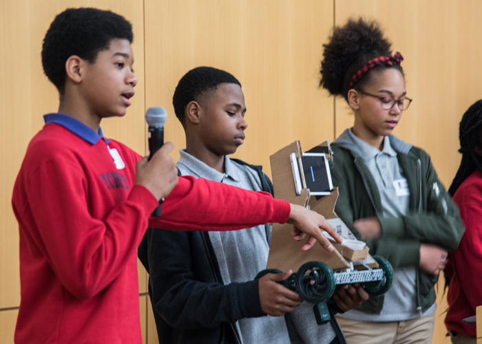 James McHenry Elementary Middle School students (from left) Raynod Murray, Tyrone Williams, Saniya Abrims, and Jania Ware present a miniature prototype of thier robotic invention, a service-bot for geriatric patients.