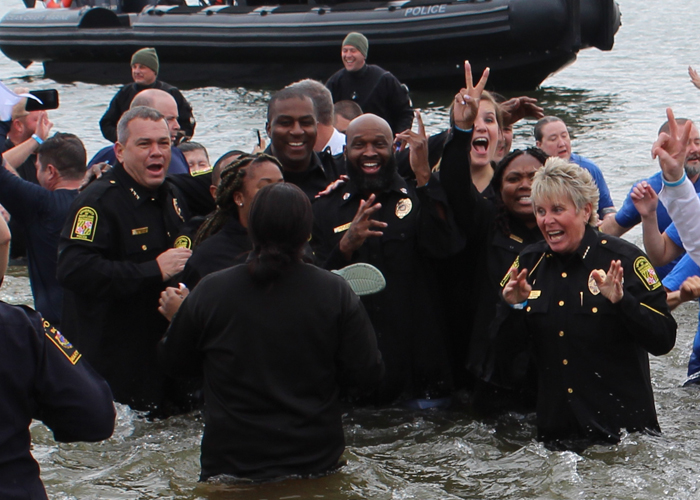 Chief Alice Cary (right) and other members of the University of Maryland, Baltimore Police Department plunge into the frigid waters of the Chesapeake Bay.