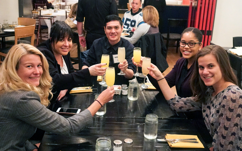 (From left) Erin Teigen, Adrienne Thomas, McMillan Ching, Dominique Earland, and Jenny Breau toast their victory after receiving the grand prize in the sixth annual D.C. Public Health Case Challenge. Team member Chigo Oguh is not pictured.