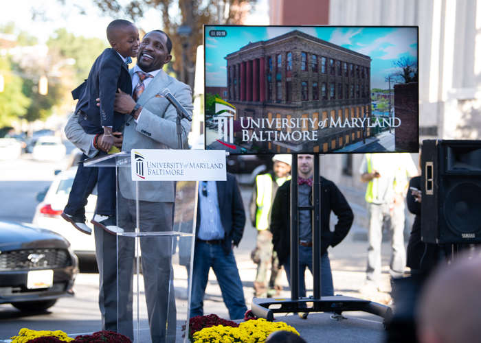Pro Football Hall of Famer, Ravens legend, and new UMB Foundation board member Ray Lewis brings second-grader Blair Pinnacle III onto the stage at the ceremonial groundbreaking of UMB’s new Community Engagement Center.