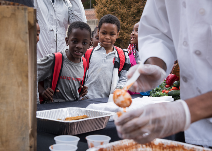 Third-grade students from James McHenry Elementary/Middle School watch a healthy cooking demonstration with spaghetti squash at the University Farmers Market.