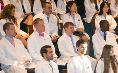 School of Dentistry first-year students donned their white coats for the first time in historic Davidge Hall.