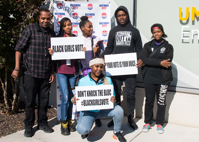 Students from Augusta Fells Savage Institute of Visual Arts cast their ballots as first-time voters, after members of Black Girls Vote helped shuttle them over to the UMB Community Engagement Center voting site from their high school.