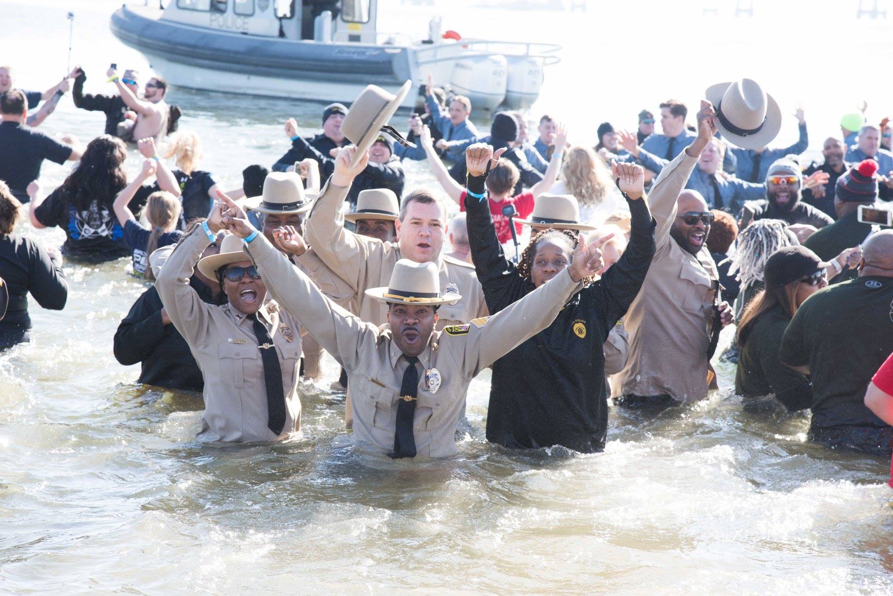 UMB police officers dive headfirst into the frigid waters of the Chesapeake Bay to raise money for the Maryland Special Olympics at the 2018 Polar Bear Plunge.