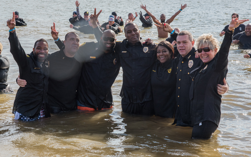 From left: Lt. Matthew Johnson, Lt. Todd Ring, Pfc. Joseph Fair, Pfc. Edouardo Edouazin, police dispatcher Erika Malone, Lt. Thomas Leone, and Chief Alice Cary strike a pose after plunging into the freezing Chesapeake Bay for the annual Polar Bear Plunge.