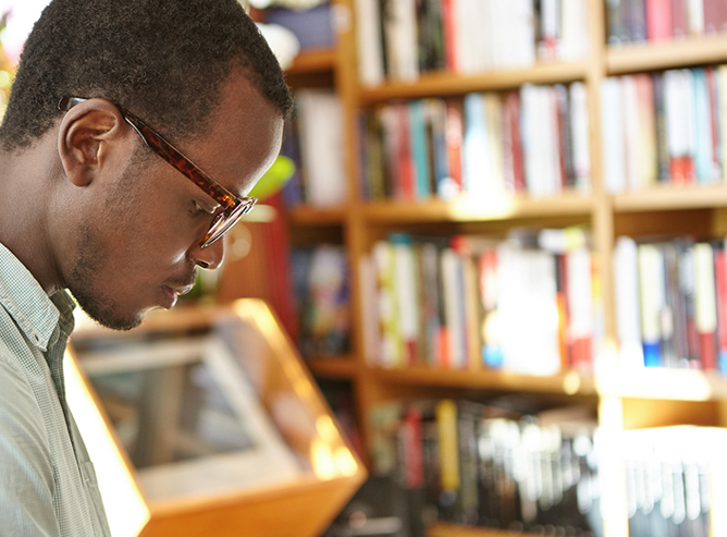 Man reading book at bookstore