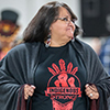 Indigenous women wearing a t-shirt that says Indigenous strong