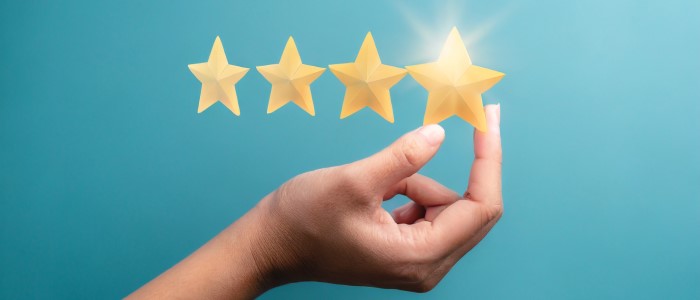 woman's hand putting the stars to complete five stars