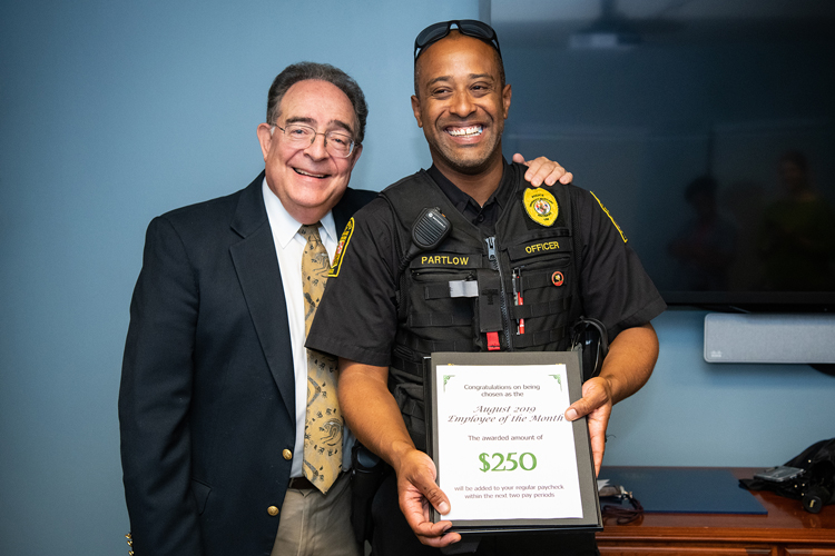 Photo of UMB Police Officer Yale Partlow alongside President Jay A. Perman.
