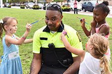Lt. Johnson having his face painted by children