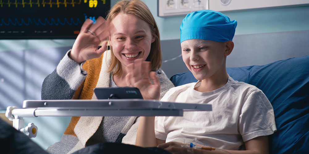 A seriously ill child patient and their sibling together in a hospital.