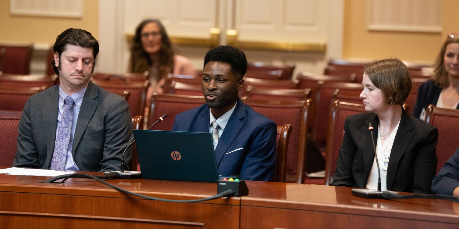 Law student Davon Nixon (center) testifies before a Maryland Senate committee.