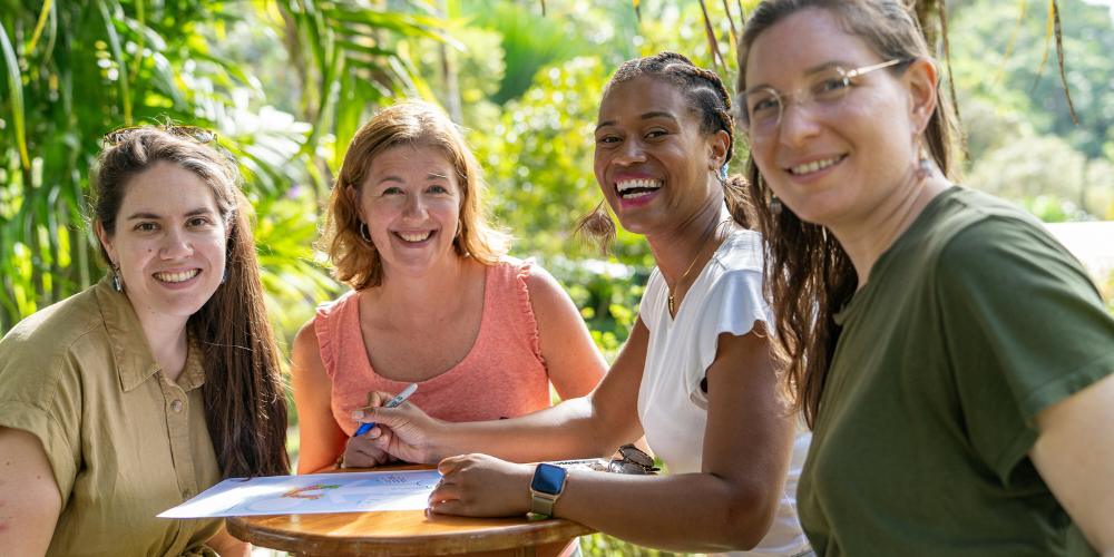 Four women stand at a table outside in Costa Rica