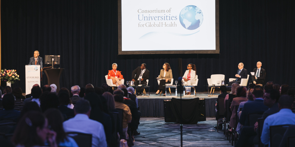 Panelists onstage at a CUGH conference.