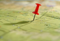 A pushpin on a map.