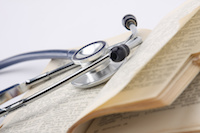 A stethoscope resting over a book.