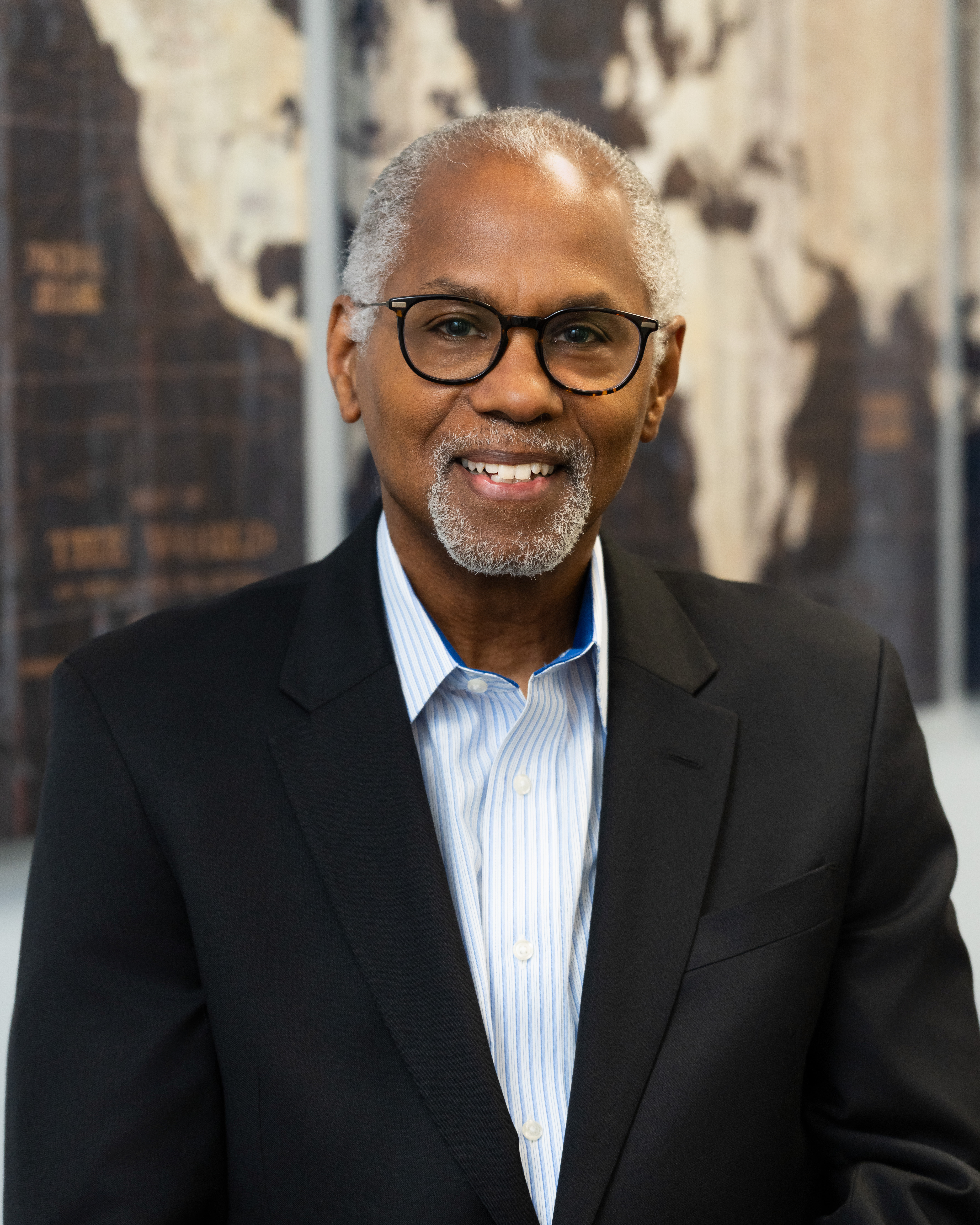 Smiling man dressed in a suit.