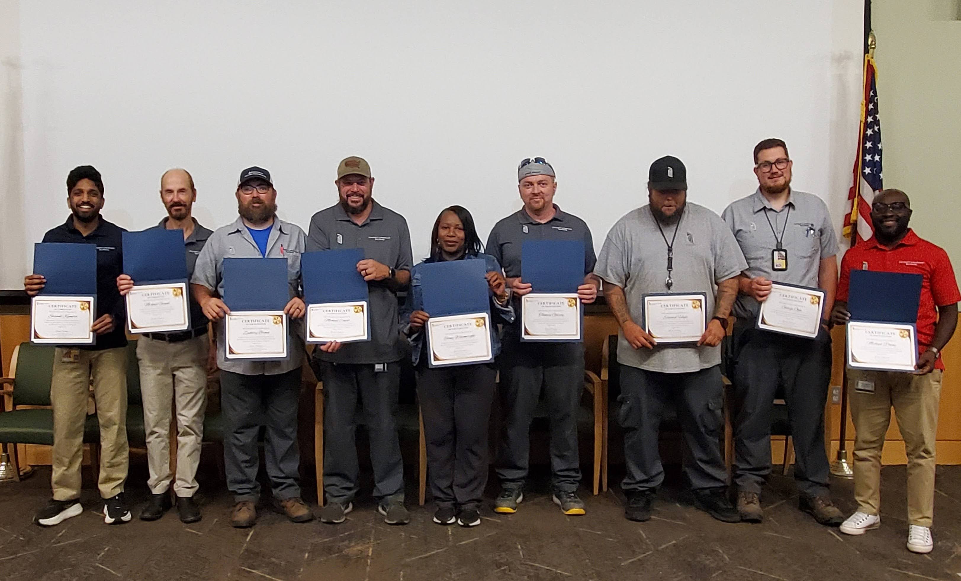 Members of O&M pose with awards