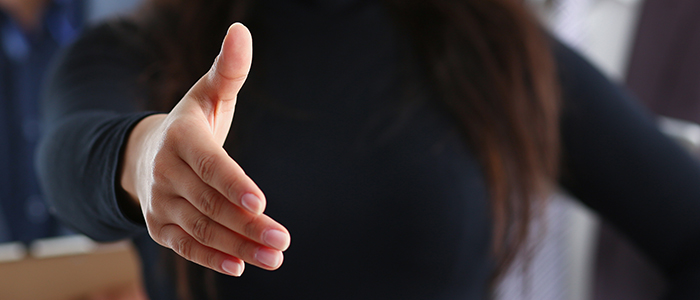 A person reaching out for a handshake