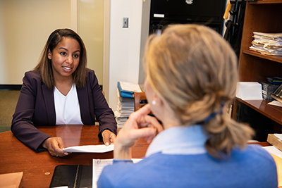 A student talking to a client