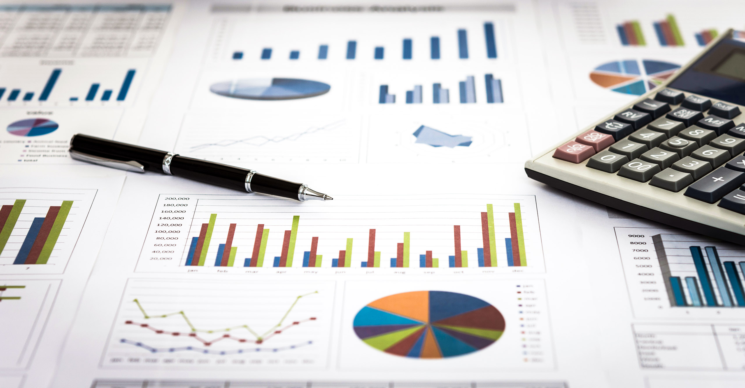 image with various accounting tools such as pen, calculator and graphs