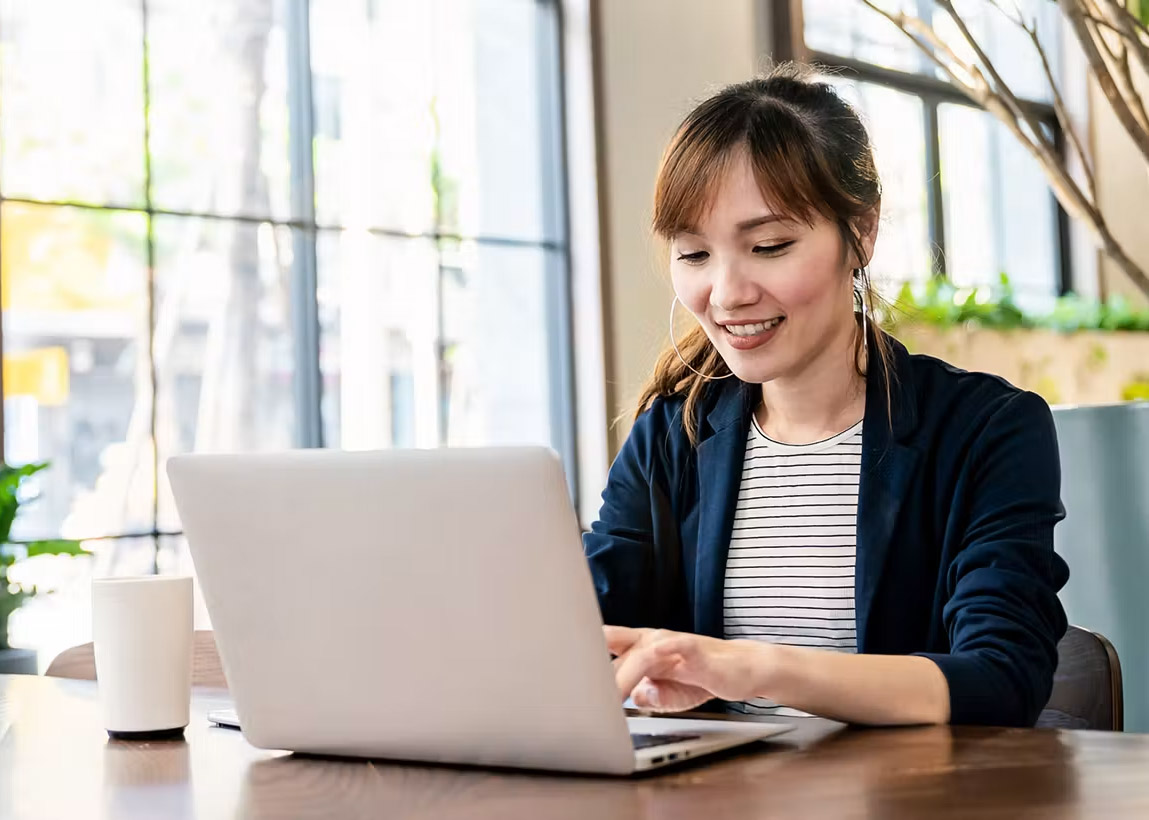 woman typing on a laptop