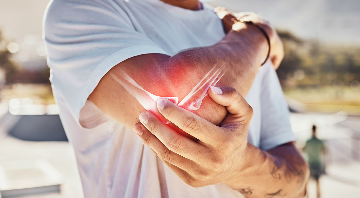 person holds a painful elbow