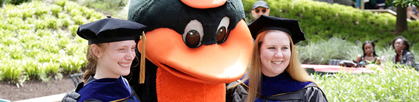 two students with the Baltimore Orioles mascot