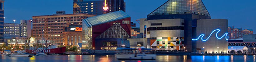 water bay area with lite up buildings which is also known as the Baltimore Inner Harbor