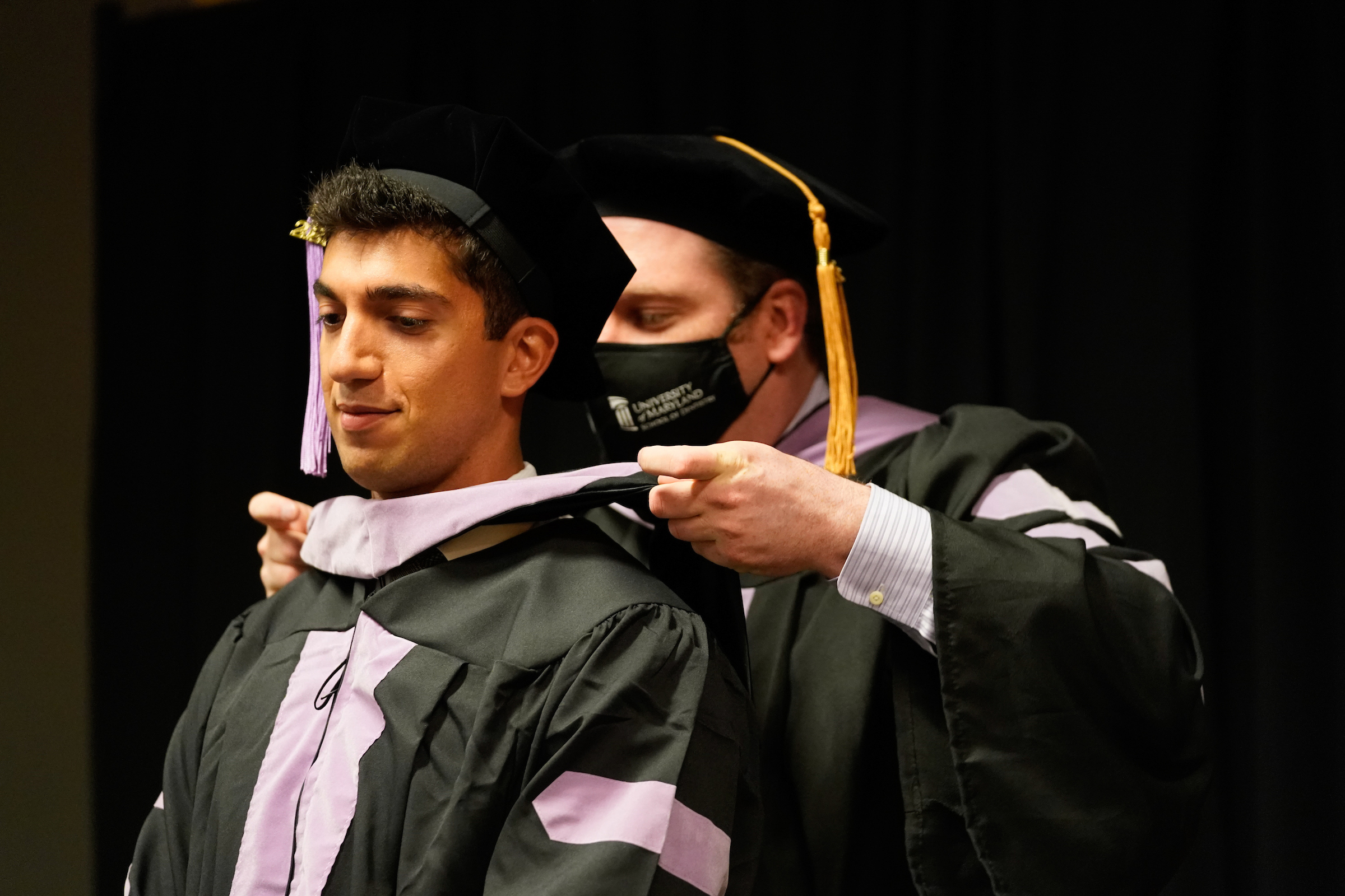 A School of Dentistry graduate receives their hood